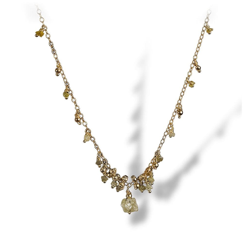 A dainty necklace of textured enriched 18K yellow fine gold beads with rough diamonds