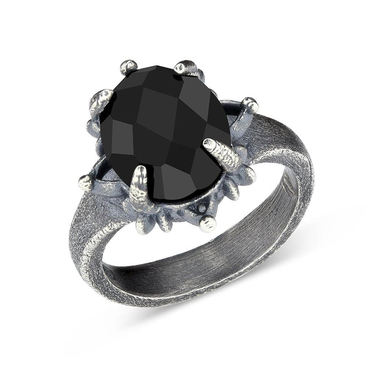 A cocktail ring of an intricate floral design with detailing of textures and of high quality faceted onyx