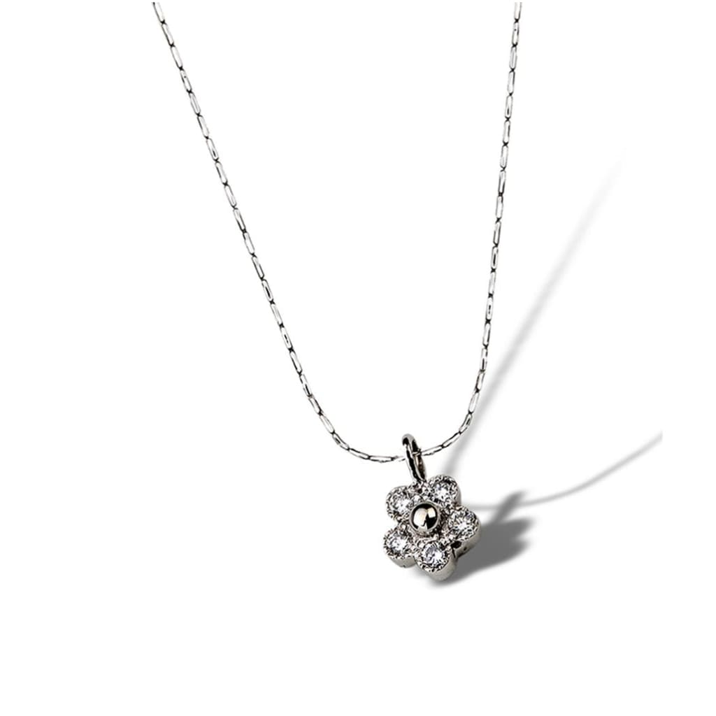 Tiny diamonds sparkle in this petite budding floral daisy pendant