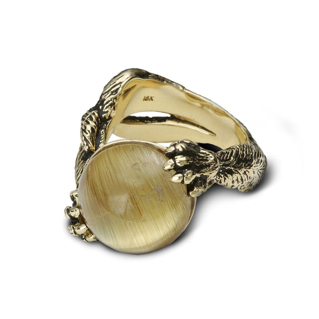 A bypass kitty cat ring, in gold and blackened finish, in its playful pose 
