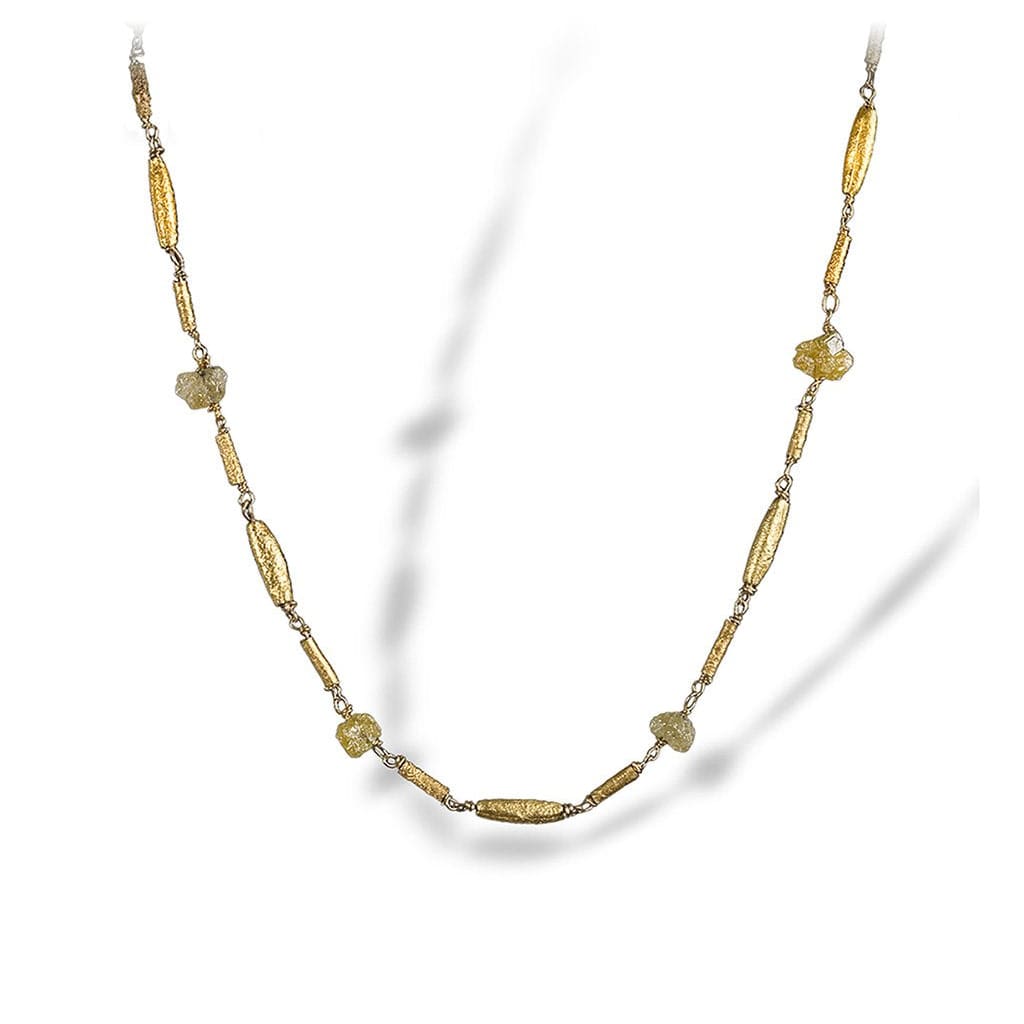 Textured necklace of enriched 18K yellow fine gold combination of tubular sizes with rough diamonds 