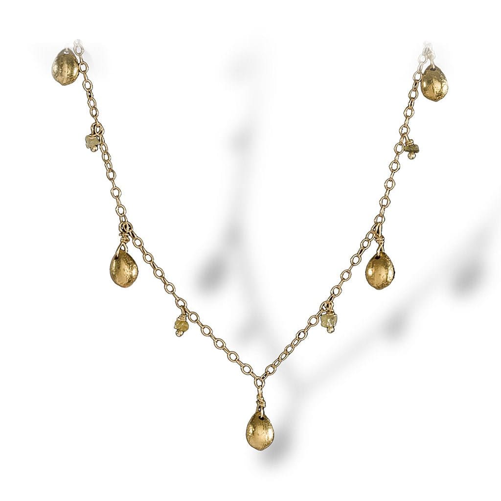 A dainty necklace of textured enriched 18K yellow fine gold teardrops with rough diamonds 