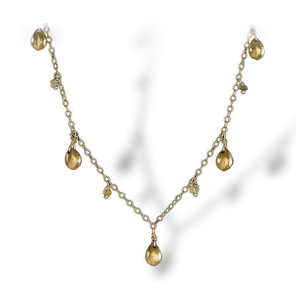 A dainty necklace of textured enriched 18K yellow fine gold teardrops with rough diamonds 