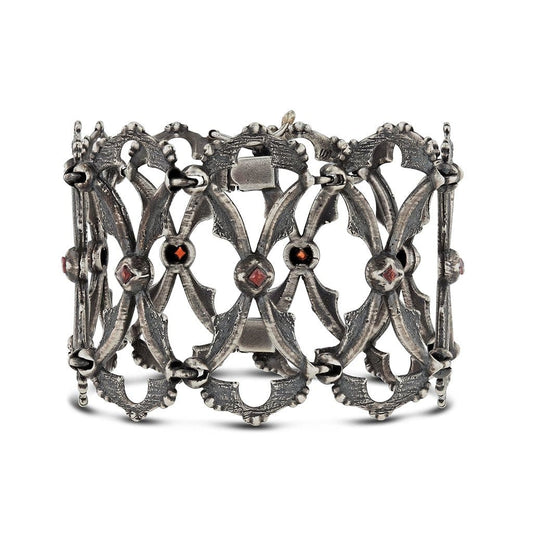 A linked bracelet cuff with texture and detailed in intricate gothic vintage design