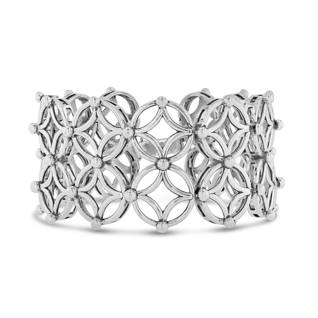 A geometric bracelet in a matrix pattern of diamond and circle motifs with beaded detailing 