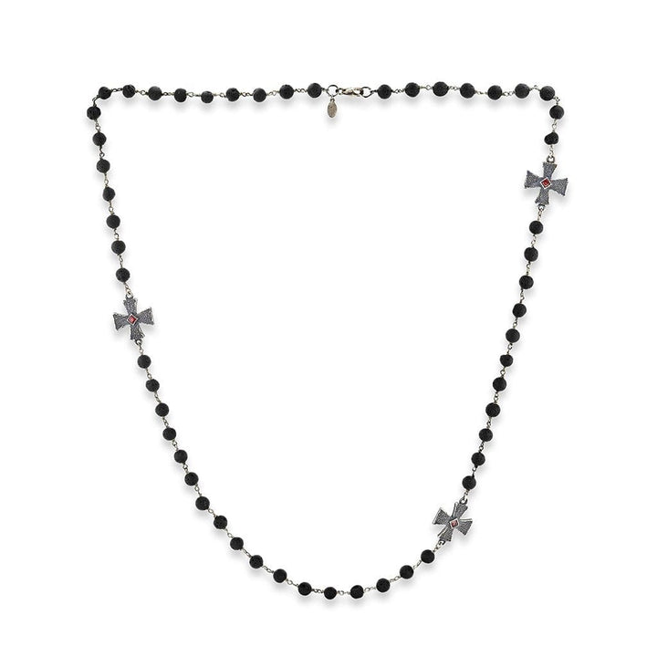 A rosary-inspired necklace of lava rock beads and Maltese crosses with splendid garnets