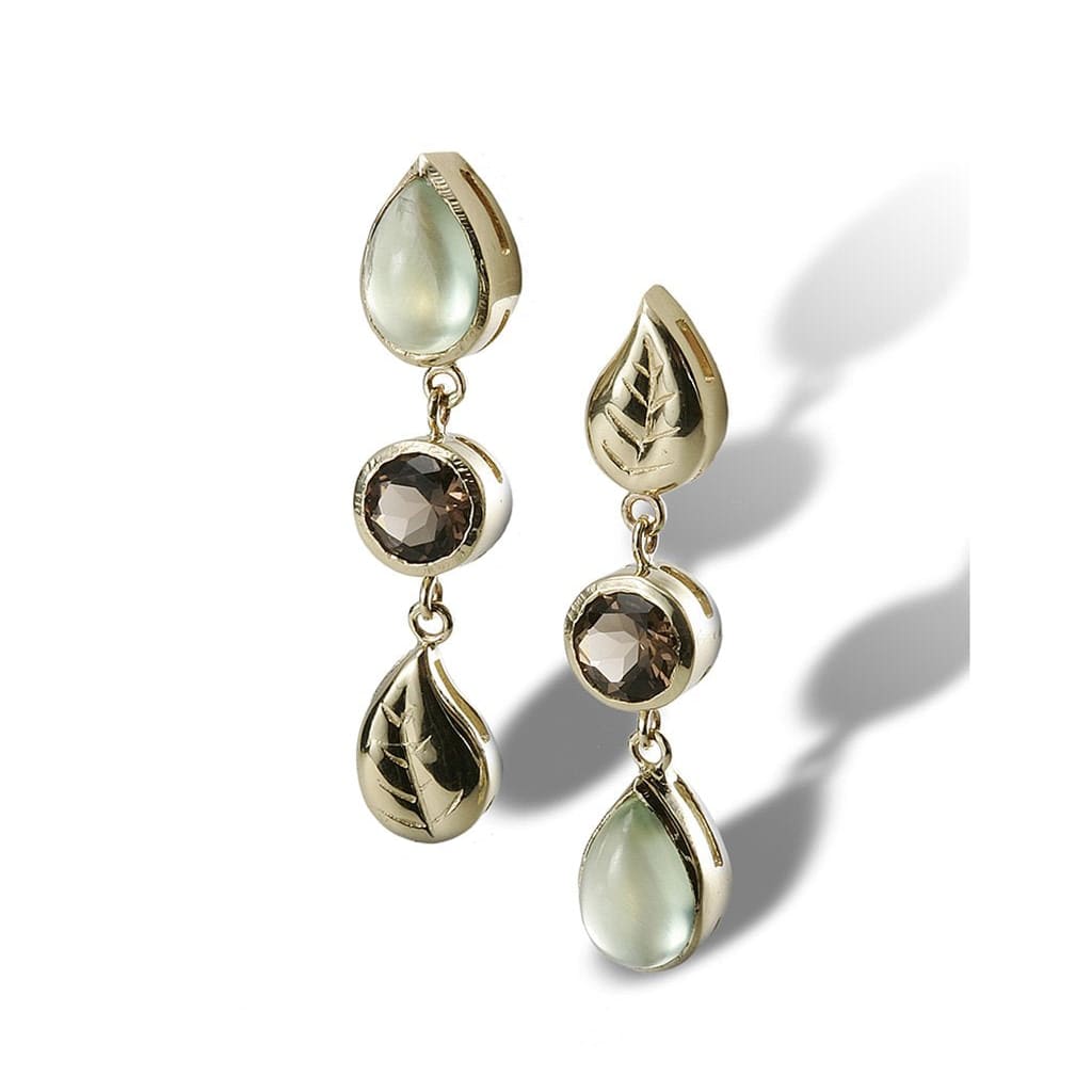 An earring with an alternating design of leaves and gemstone drops in fine gold