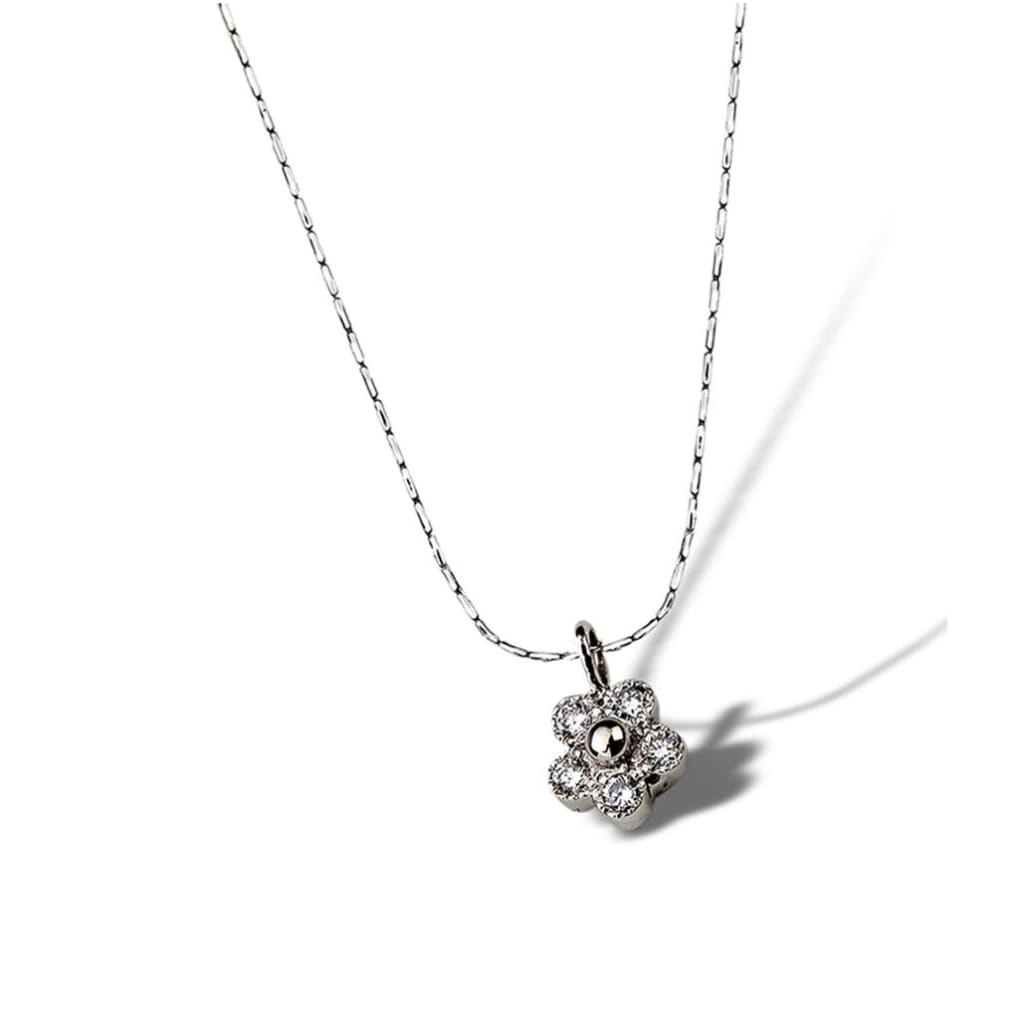 Tiny diamonds sparkle in this petite budding floral daisy pendant 